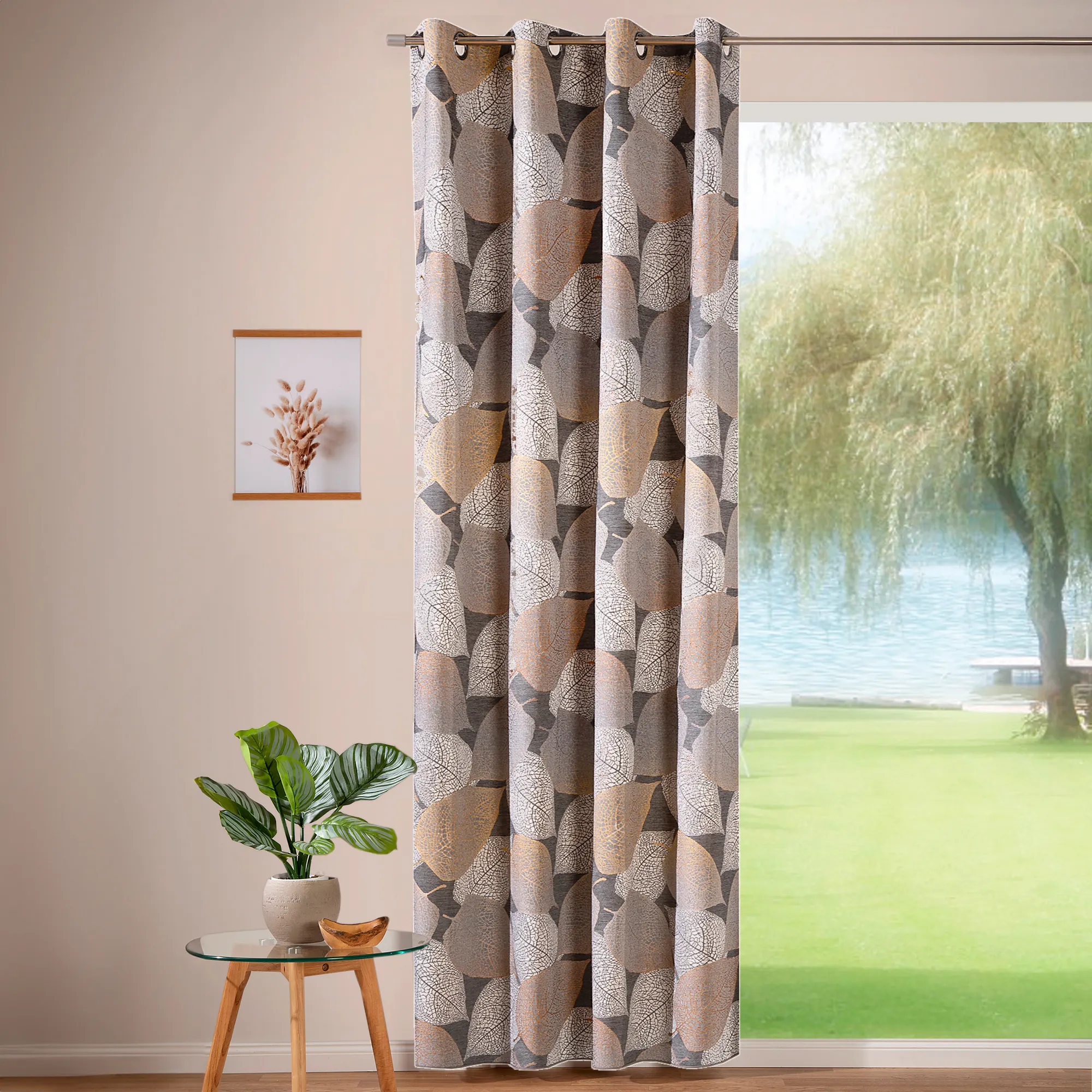 Tenda ad anelli con motivo fogliare davanti a una finestra con vista su giardino e lago