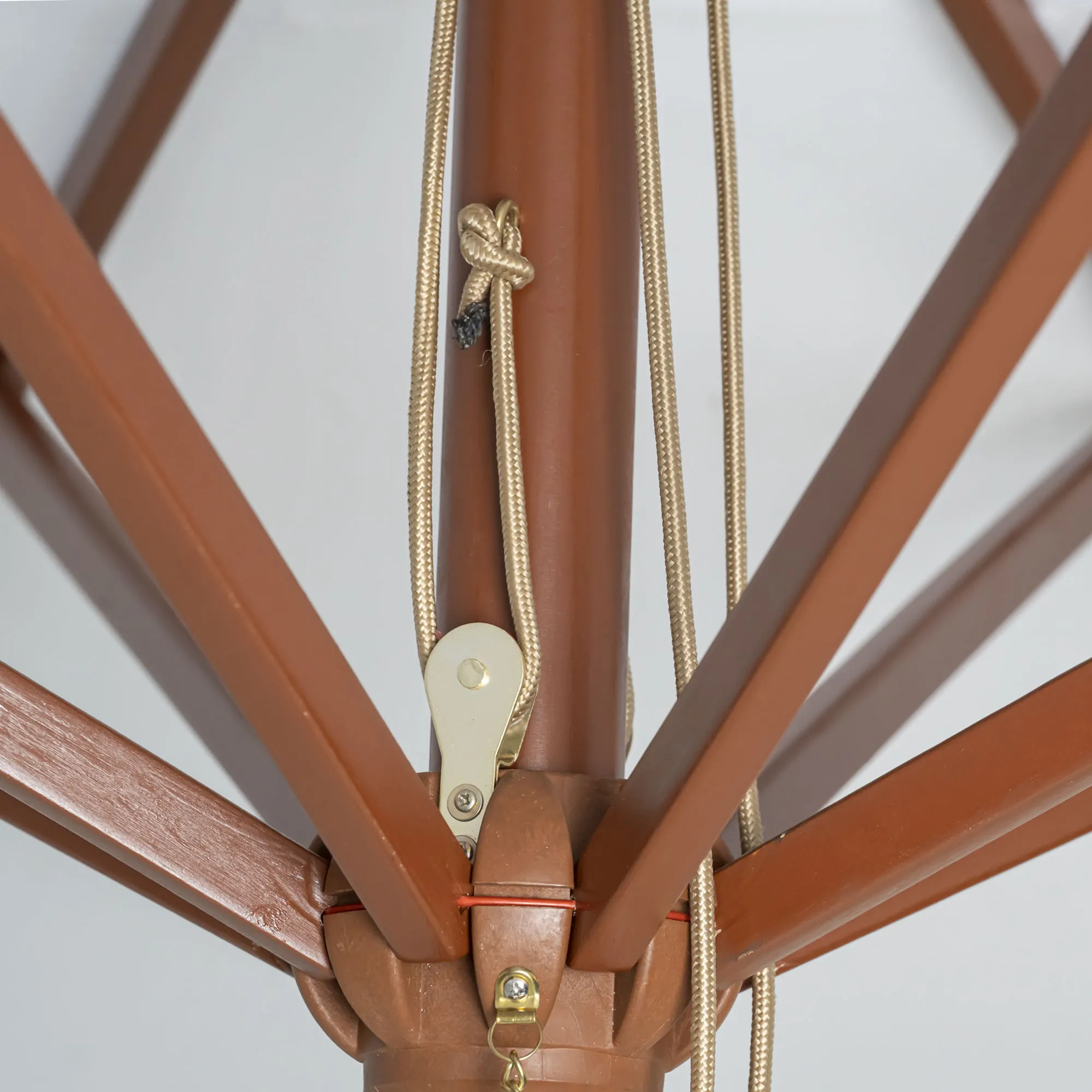 Primo piano di un ombrellone in legno pieghevole con meccanismo a corda